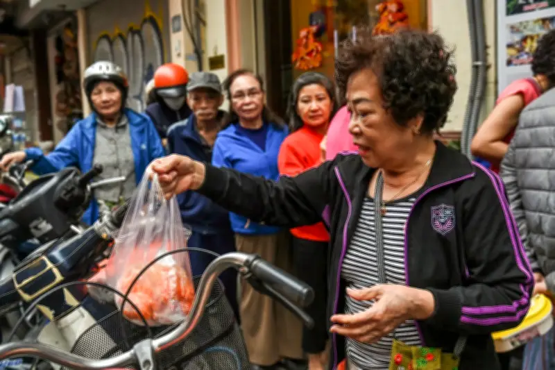 Người dân Hà Nội xếp hàng dài trên phố cổ để mua đĩa xôi cúng Rằm tháng Giêng