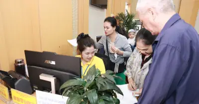 Nhân viên bưu điện hỗ trợ người dân nộp hồ sơ trực tuyến