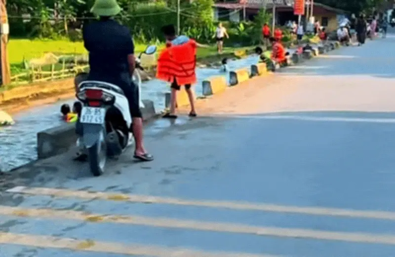 Video: Hàng chục người tắm mát dưới con mương nằm sát đường lớn